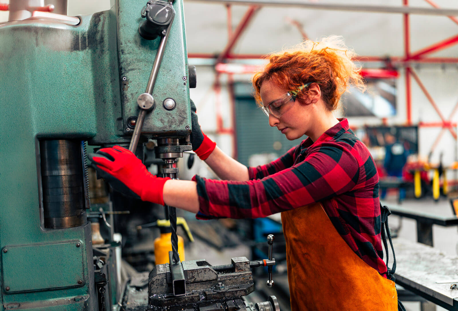 Woman using a drill press