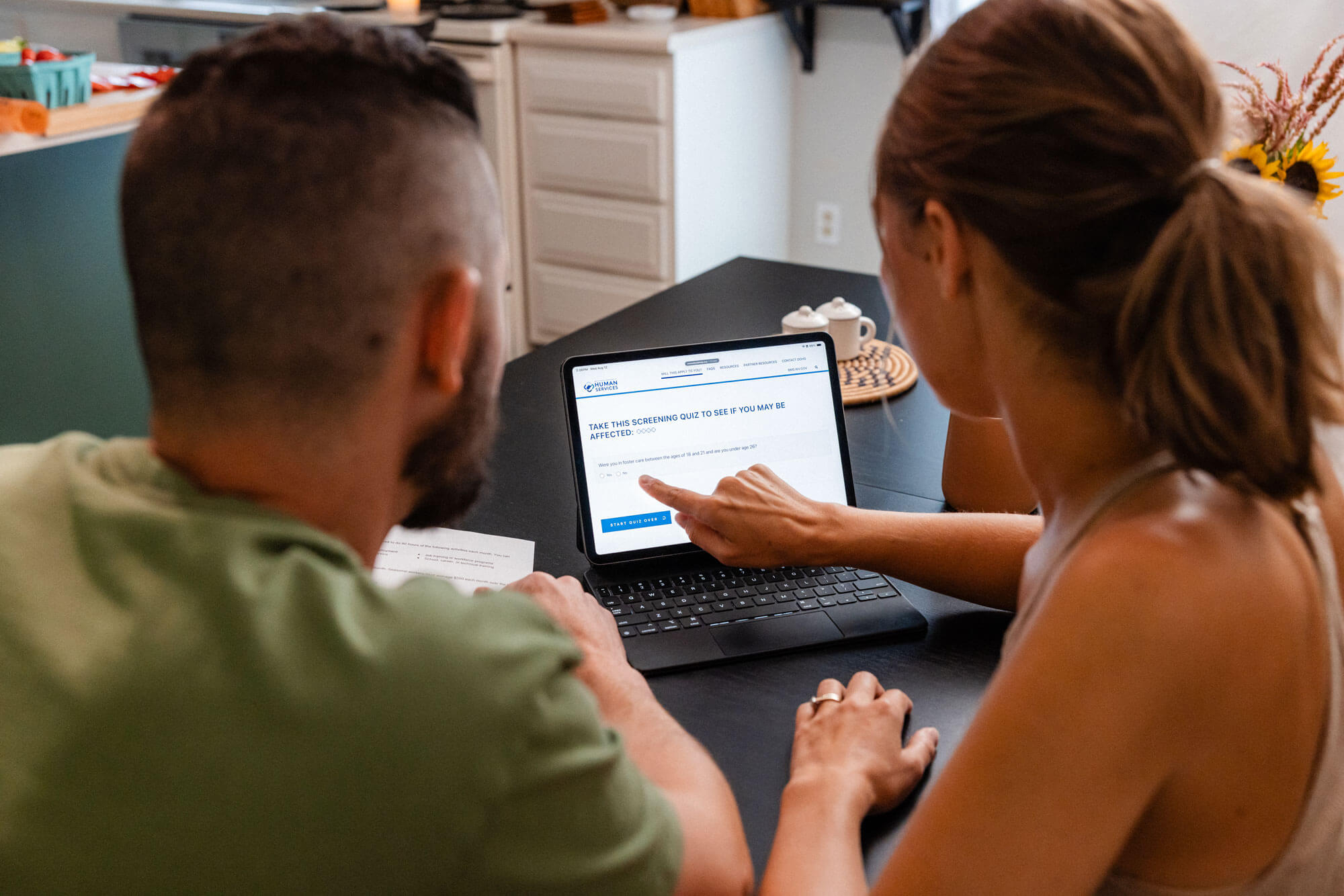 Couple taking the screening quiz on a tablet.