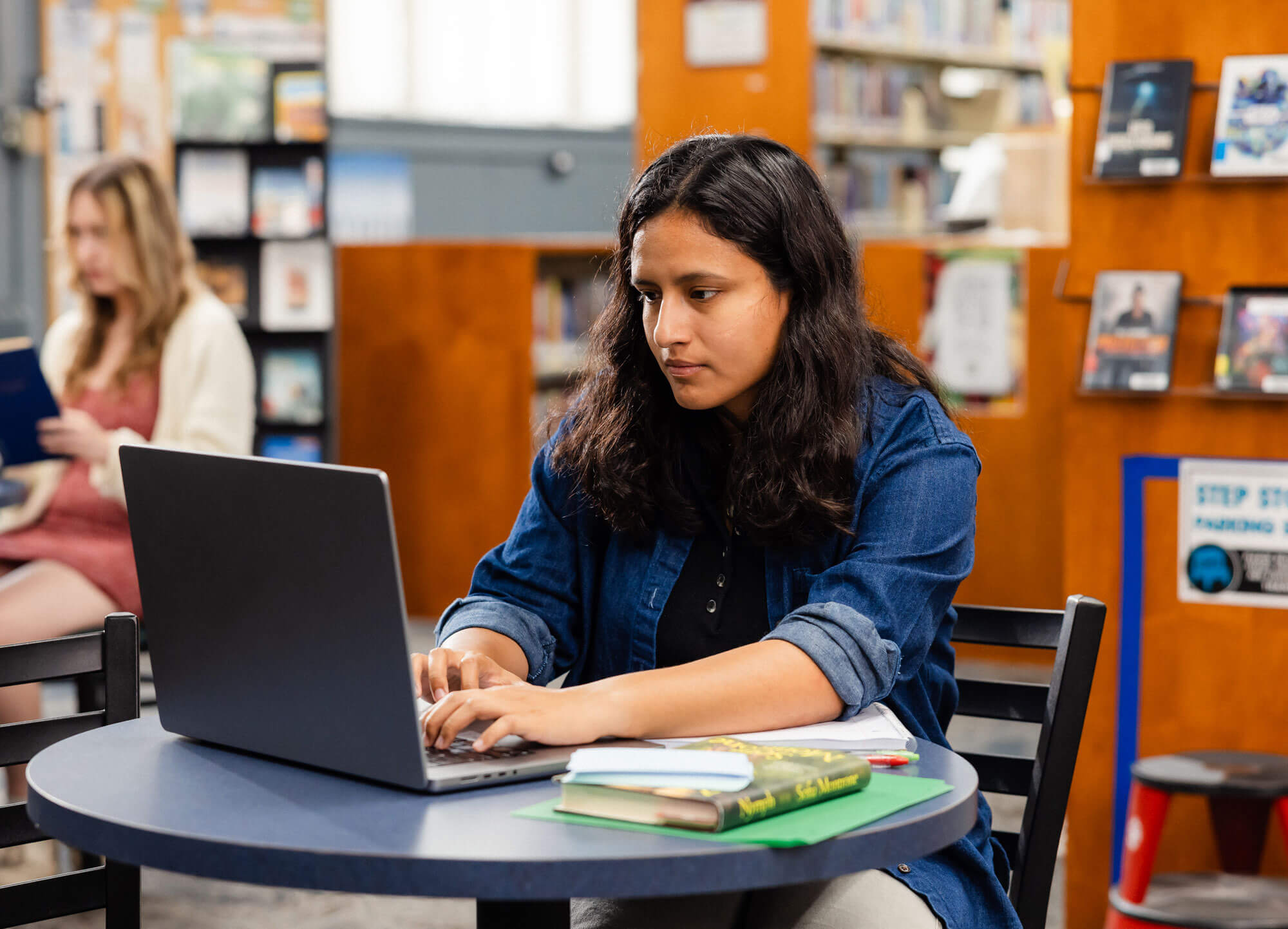 Woman at a computer in the library.